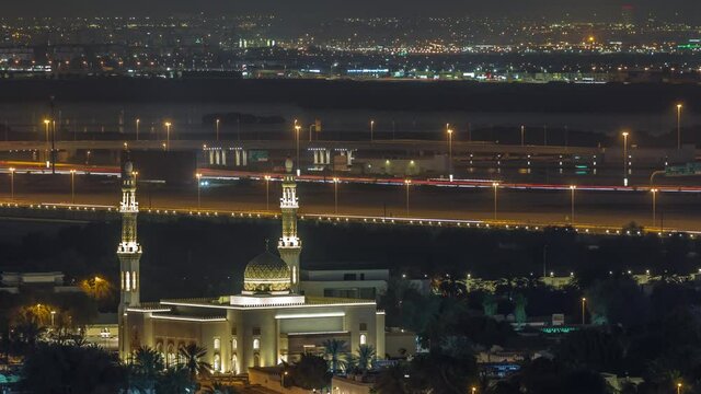 Aerial view of mosque and neighbourhood Deira on a background night timelapse. Dubai, United Arab Emirates