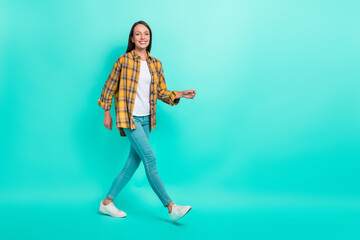 Full size profile photo of hr mature brunette lady walk wear shirt jeans footwear isolated on turquoise background