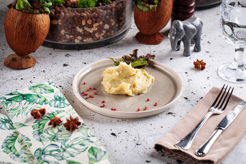 Portion of mashed potato garnish on decorated background
