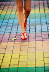 woman walking across colorful lgbtq crosswalk