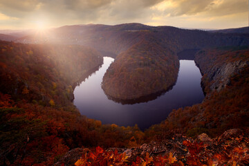 Autumn landscape. River canyon with dark water and orange fall forest. Horseshoe bend, Vltava river, Czech republic, Europe. Beautiful landscape with river, Maj lookout. Autumn in Europe, sunset.