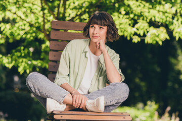 Portrait of attractive dreamy cheery girl pastime free time sitting on chair enjoying staying on...