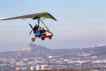 Flight on a motorized paraglider in mountainous terrain