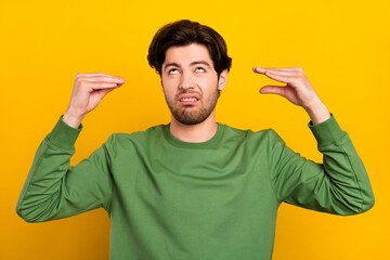 Photo of unhappy upset bored man hold hands speak conversation people isolated on yellow color background