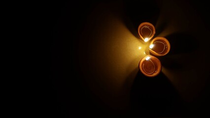 glowing diyas in dark for diwali greetings © ChayachitrabySmayana
