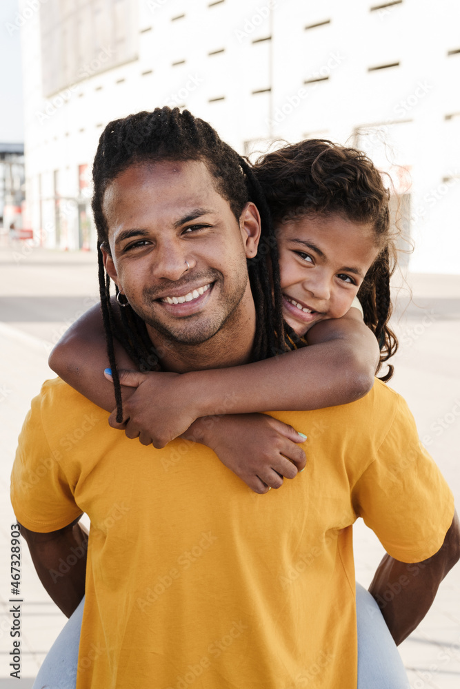 Wall mural a beautiful portrait of dominican father and daughter looking at camera