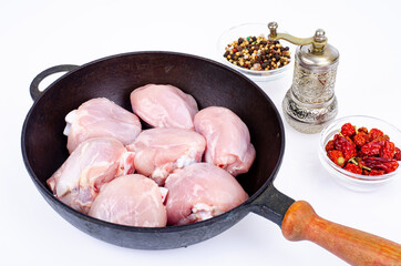Raw pieces of chicken leg in skillet for cooking. Studio Photo.