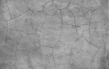 old cracked gray wall from an ancient facade - weathered and damaged surface texture for a blank background 