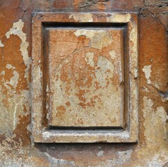 Rectangle with a frame from the ornament of an old and damaged facade of an ancient house - chipped brown painting and cracks texture for a background