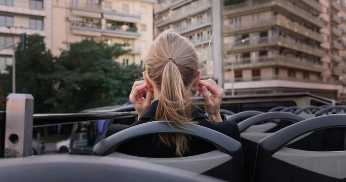 Woman on double decker city tour in Greece, Thessaloniki.
