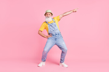 Full length body size view of attractive cheery funny man showing copy space isolated over pink pastel color background