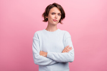 Fototapeta na wymiar Photo of unhappy upset doubtful young woman hold hands crossed bad mood dislike isolated on pink color background