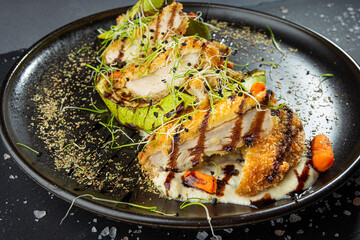 Chicken breaded fillet with zucchini, baby carrot and sprouts. Original presentation
