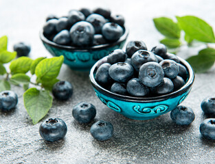 Freshly picked blueberries on a concrete background. Concept for healthy eating