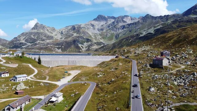 Aerial drone footage of the 
Montespluga dam and lake in Italy in the alps along the Splugen pass toward Switzerland. 