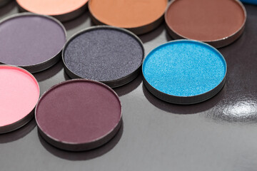 Close-up texture make-up eyeshadow palette. Abstract texture. Colorful colors. Highlighter. Professional make-up product. Flat lay. Macro photography. Set dry eyeshadow