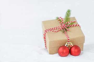 Fototapeta na wymiar Christmas background - Christmas present and Christmas ornaments in the snow 