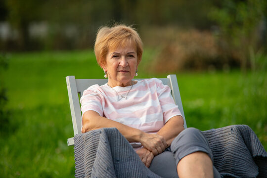 A woman sits in a chair in the fresh air