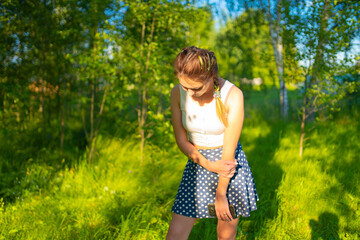 A girl in a white T-shirt in a park