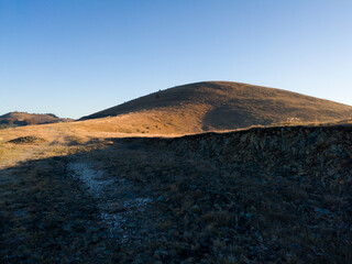 Mountain peak Crni vrh on the mountain Zlatibor in Serbia illuminated by the morning sun in autumn