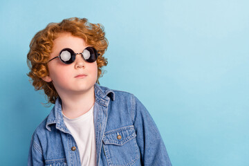 Photo portrait curly little boy looking blank space wearing fashionable sunglass isolated pastel...