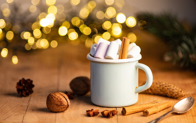 cup of hot chocolate  with marshmallows  cinnamon sticks  cones and branches of spruce. the concept of cozy Christmas and New Year holidays