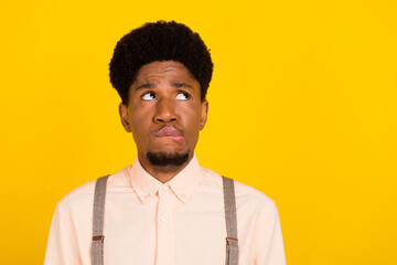 Photo portrait man with curly hair looking copyspace biting lips got problem upset isolated vivid...