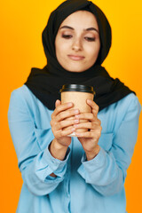 Muslim a glass of coffee a warming drink yellow background