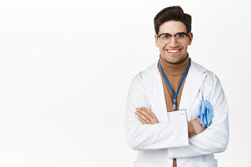 Smiling professional doctor, male physician cross arms on chest and looking confident, white background