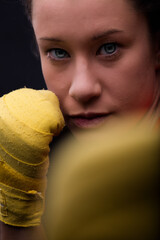 Close-up portrait of young woman boxer ready to fight