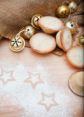 rustic setting with Christmas decorations and fruit mince pies with flour and star shapes