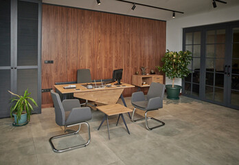 Office room and furniture table chair brown wall background and vase of plant.
