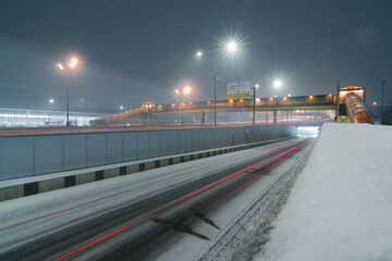 Fototapeta na wymiar tunnel and traffic in motion blur during snowfall