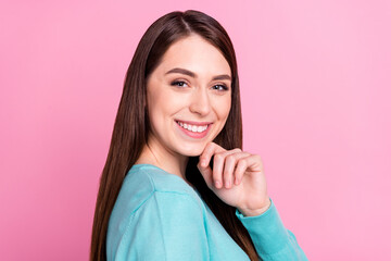 Profile side view portrait of attractive long-haired cheerful girl touching chin isolated over pink pastel color background