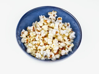 popcorn on blue bowl isolated on white background