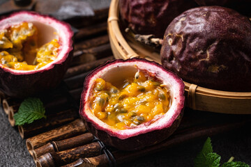 Delicious juicy passion fruit on gray table background.