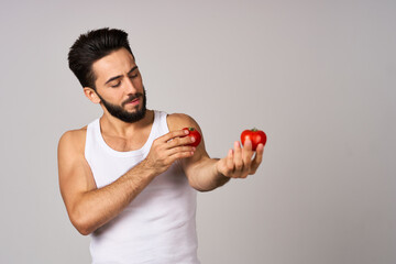 Cheerful man fresh tomatoes healthy lifestyle diet food light background