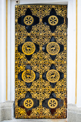 Decorative ornate door with gilded ornament in Kyiv Pechersk Lavra in Ukraine