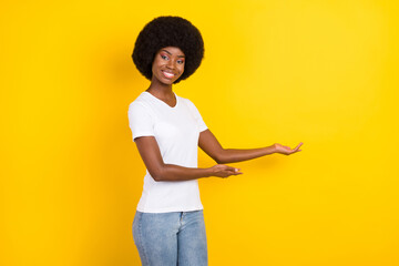 Photo of cheerful afro american young woman invite you hands smile isolated on yellow color background