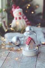 Christmas toys, a snowman and a house, balls, spruce branches, illumination on a wooden windowsill, winter, holiday