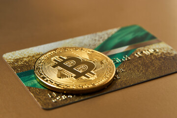 Golden credit card and bitcoin cryptocurrency