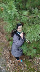 Naklejka premium Young woman resting in a pine forest