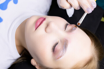 a close-up model of the eyebrow lamination procedure has laminating compositions applied to the eyebrows