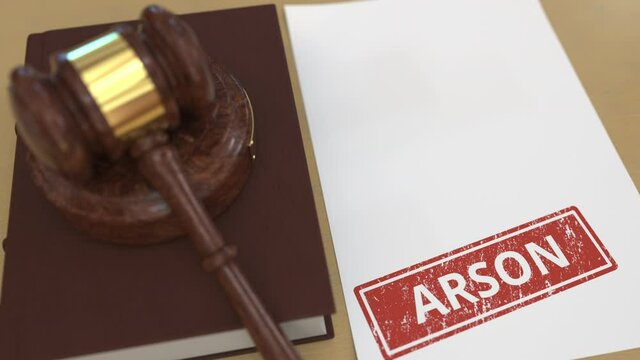 Wooden gavel and ARSON stamp on the paper. Court related 3d animation