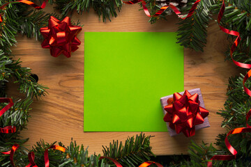 Fototapeta na wymiar Wooden background with Christmas decorations and free space for greetings or a list of guests. New year concept empty board.