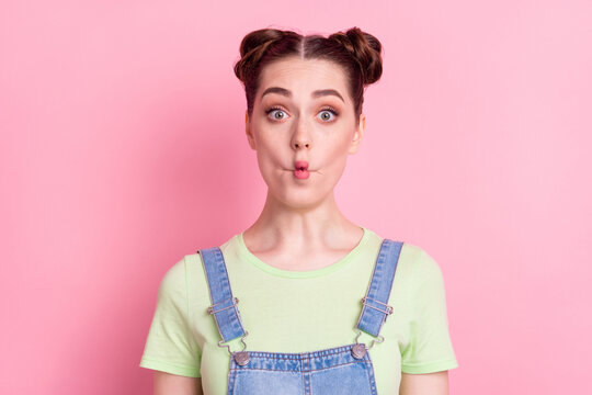 Photo portrait girl with bun fooling grimacing funny face isolated pastel pink color background