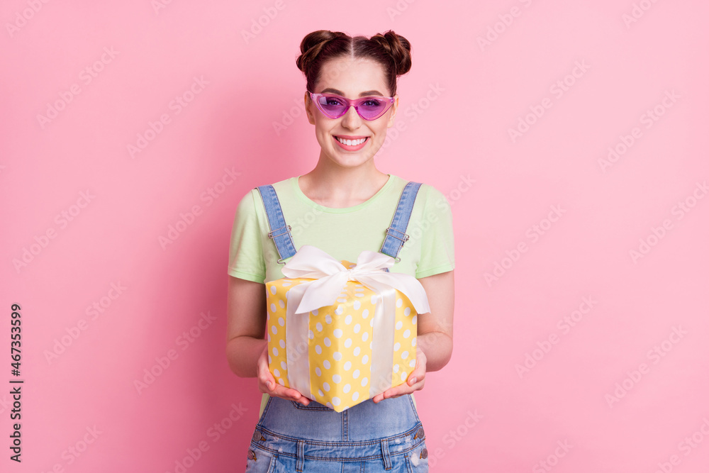 Sticker photo portrait girl in overall sunglass keeping present box isolated pastel pink color background