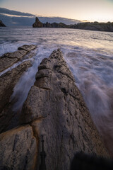Sea calm next to cliffs. Mountainous landscape by the sea.