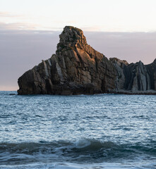 Naklejka premium Sea calm next to cliffs. Mountainous landscape by the sea.