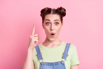 Fotobehang Photo of genius geek girl have idea raise finger open mouth wear jeans overall green t-shirt isolated on pink background © deagreez